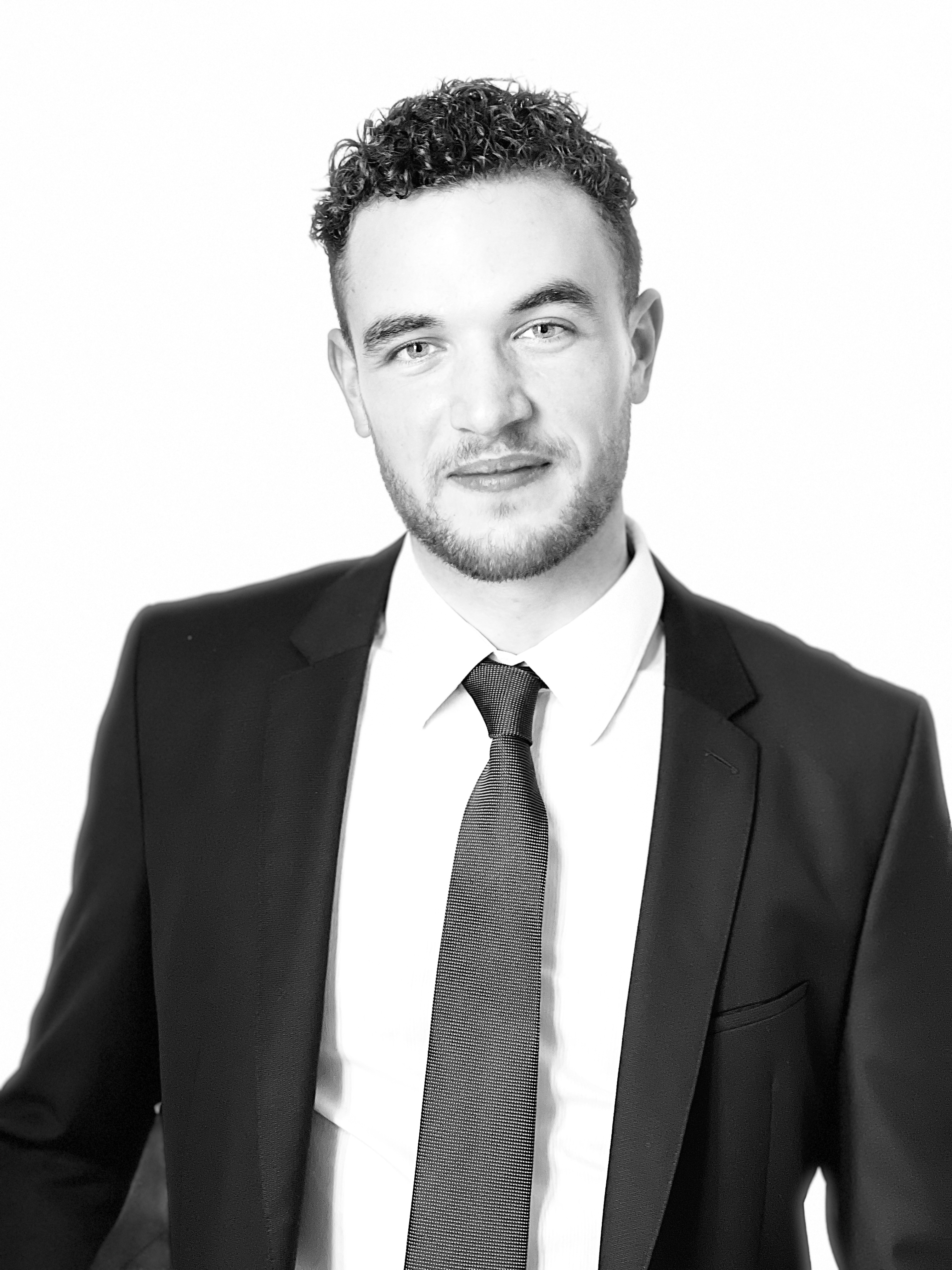 Benjamin Breton in a charcoal suit